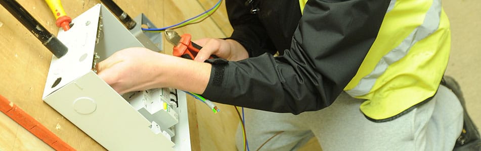 Engineering student working on a fuse box